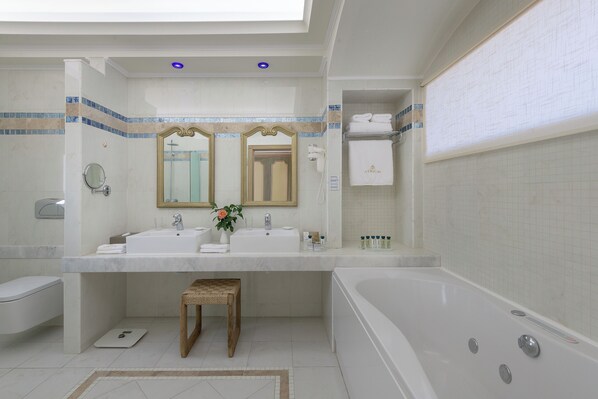 A modern bathroom with a bathtub, two sinks, a vanity, and a mirror. - Atrium Prestige Thalasso Spa Resort & Villas (Rhodes)