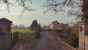 A rural road leading to a traditional stone house with a wooden gate. - The Moonraker Hotel (Trowbridge)