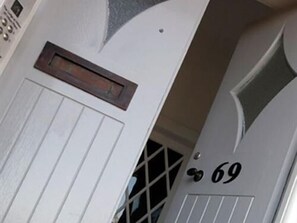 A white door with a window and a small mailbox. The number 69 is visible on the door. - Aberdeen Serviced Apartments - The Lodge (Aberdeen)