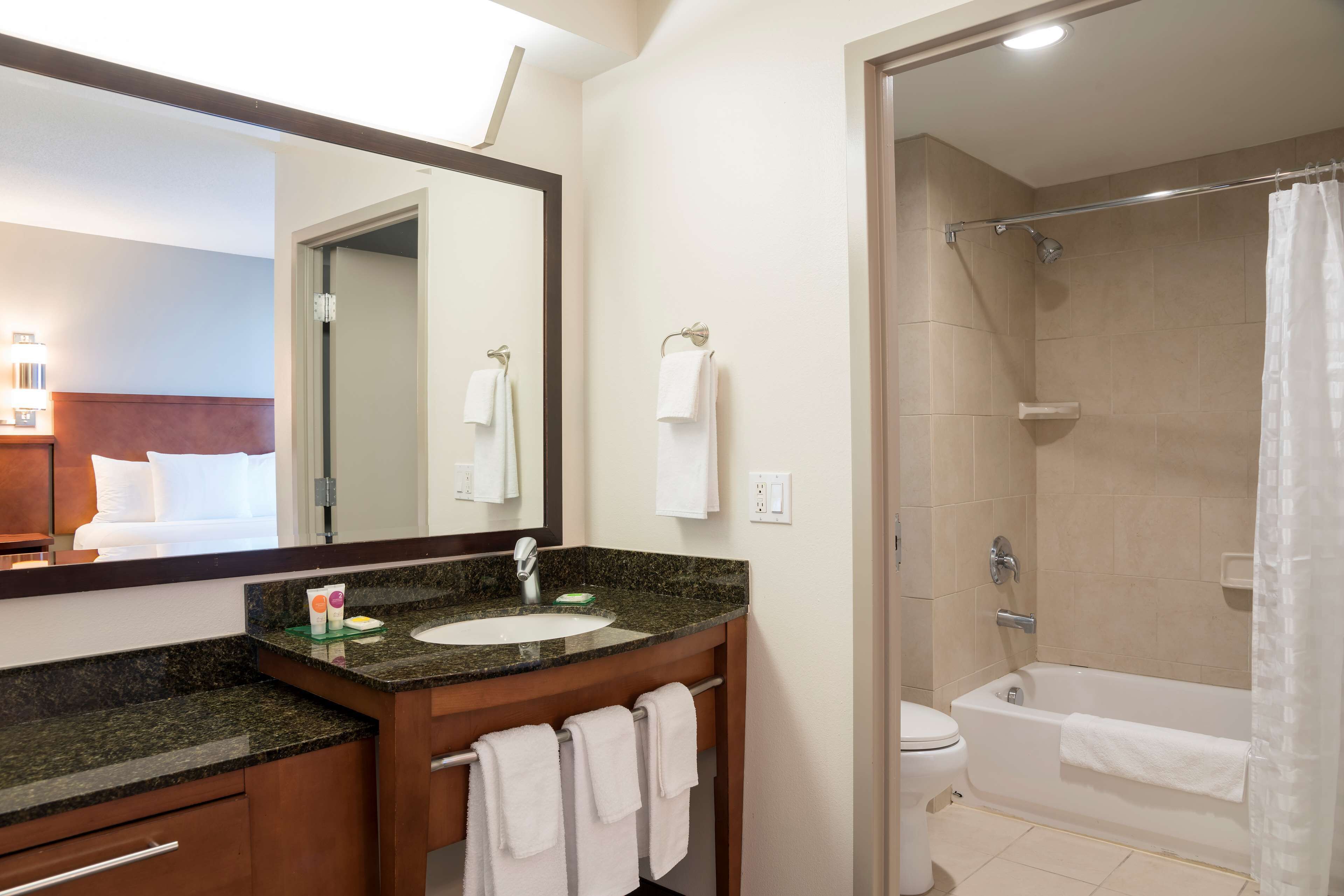 combined shower/bathtub, designer toiletries, hair dryer, towels