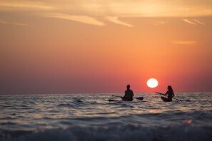 Two people sitting on a boat in the ocean at sunset. - Hyatt Place Sarasota/Bradenton Airport (Sarasota)