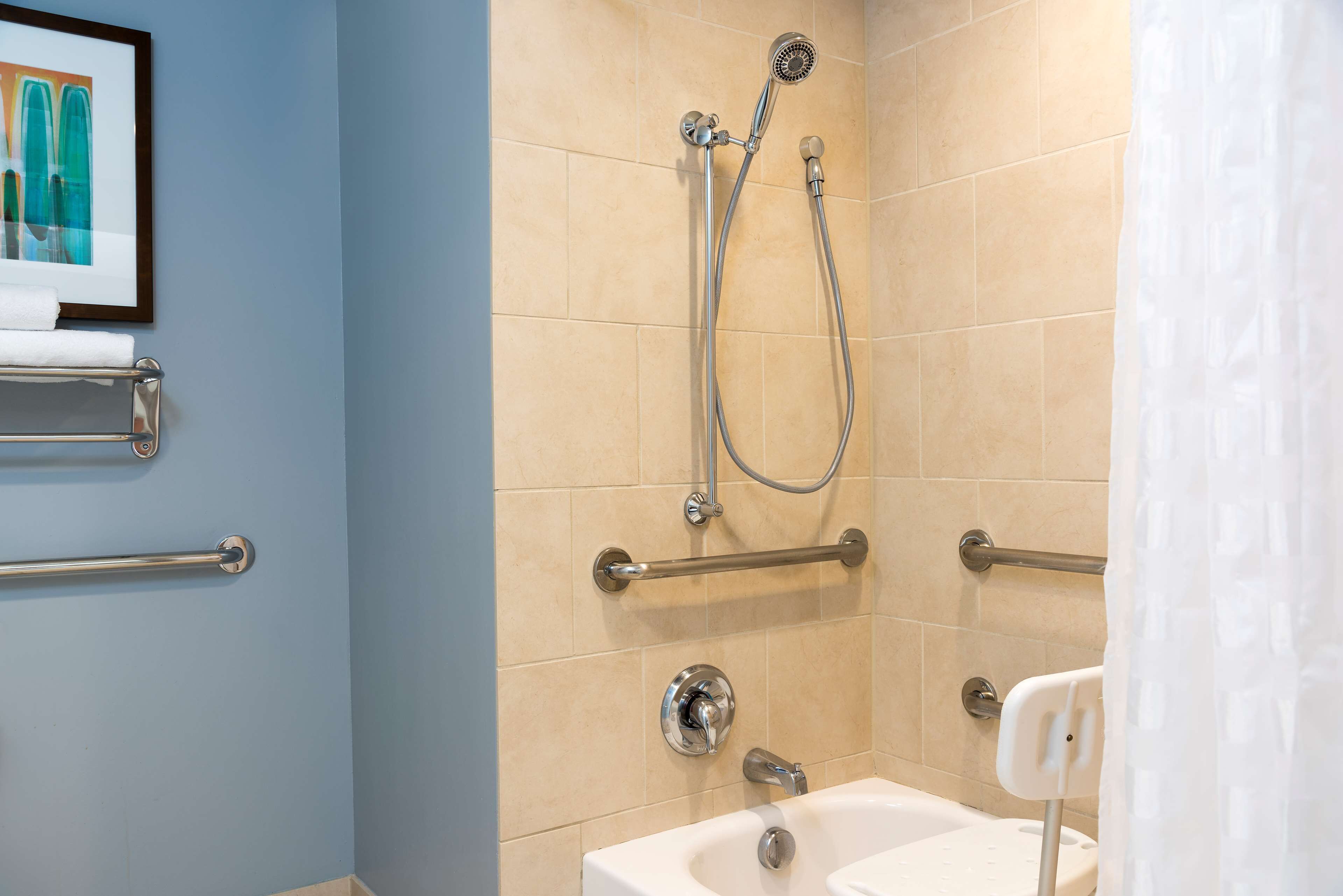 combined shower/bathtub, designer toiletries, hair dryer, towels