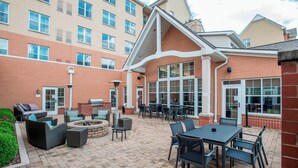An outdoor patio area with seating, a fire pit, and a barbecue grill. - Residence Inn by Marriott Cincinnati North/West Chester (West Chester)