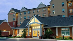 A multi-story hotel with a prominent entrance, large windows, and a brick facade. - Residence Inn by Marriott Cincinnati North/West Chester (West Chester)