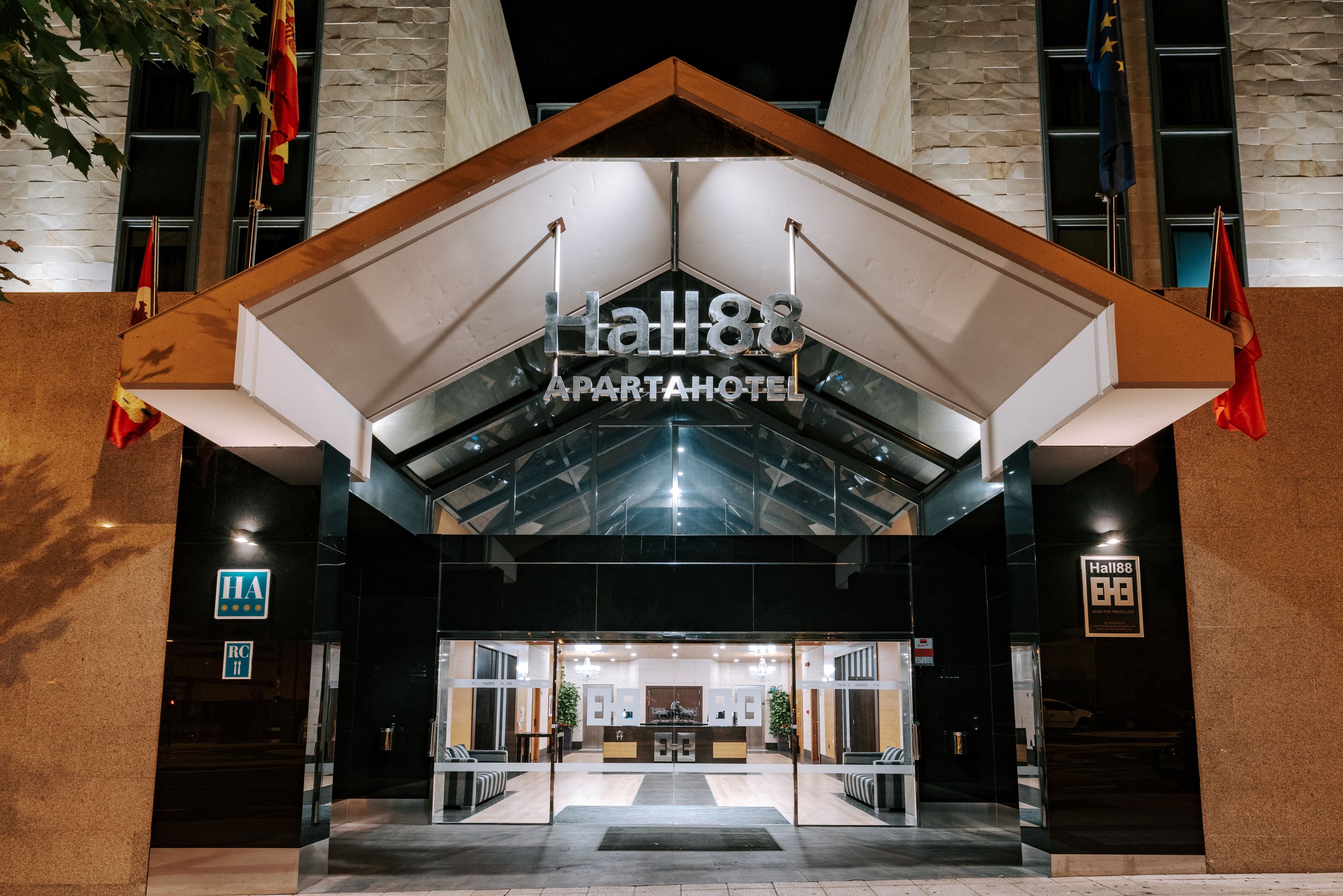 The exterior of Hall88 Apptahotel with a modern design, featuring a glass entrance and a prominent sign.
