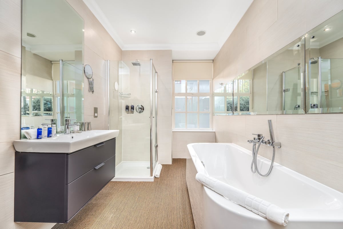 chic | bathroom | separate bathtub and shower, deep-soaking bathtub, rainfall showerhead