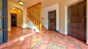 A staircase with wooden railings leading to a door marked "306". - Betlem Club Hotel (Prague)