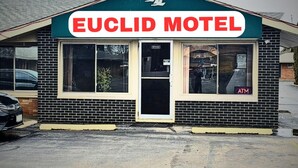 A small brick building with a sign reading "EUCLID MOTEL" above the entrance.