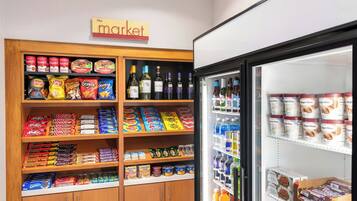 A snack and beverage display in a store with a sign above reading "the market".