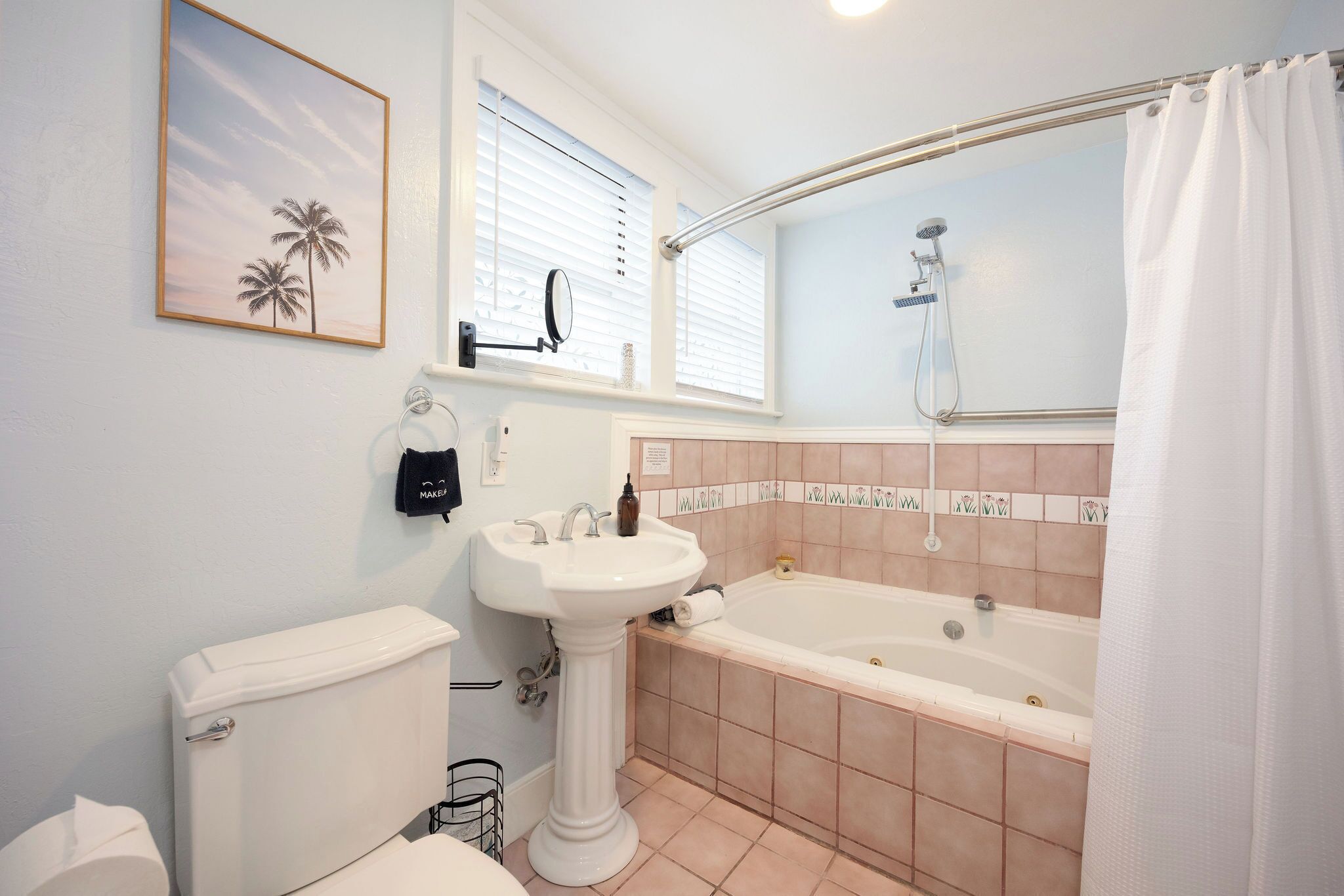 A bathroom with a toilet, sink, bathtub, and shower.