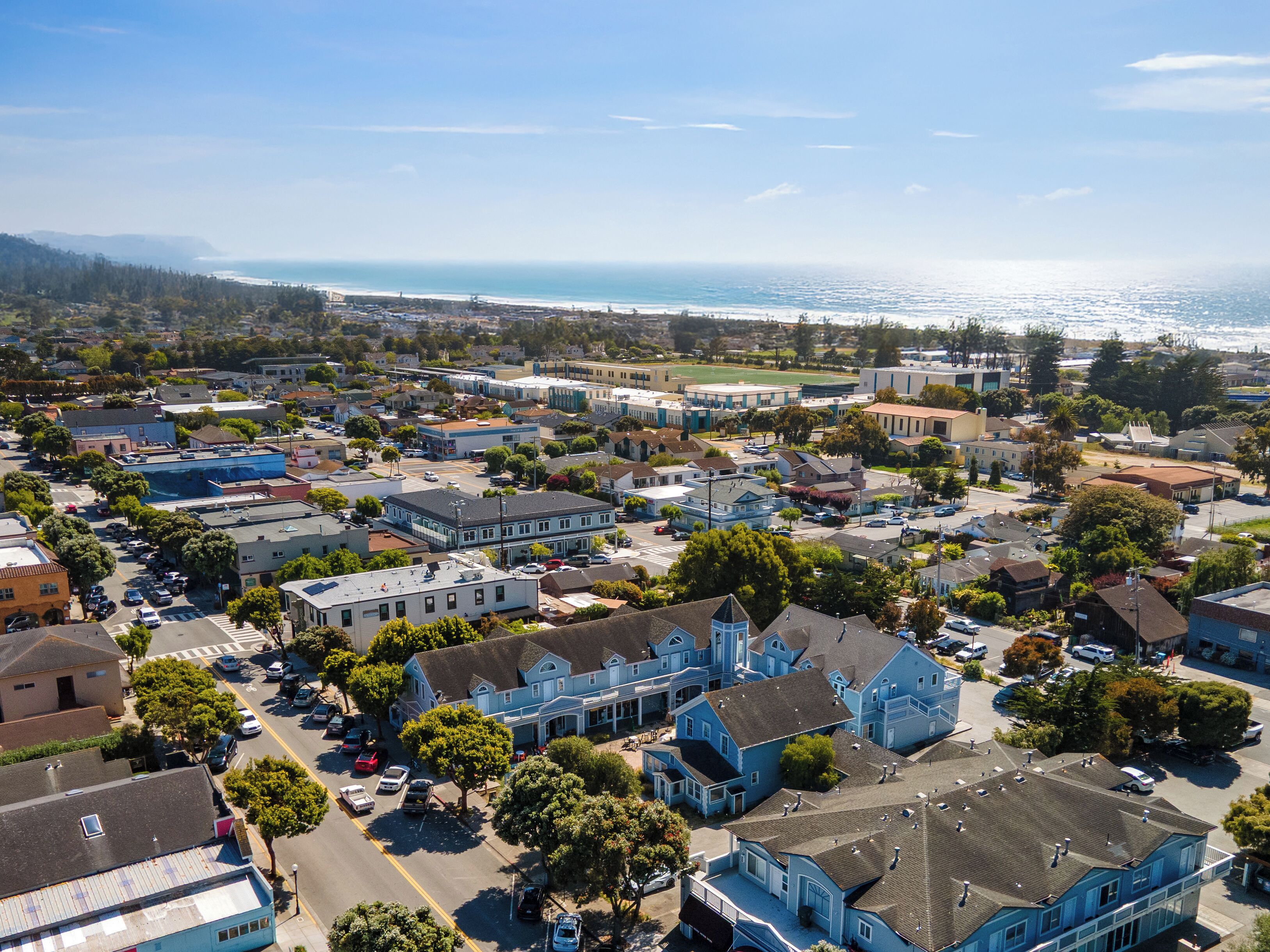 A coastal town with a mix of residential and commercial buildings, including a prominent blue church.