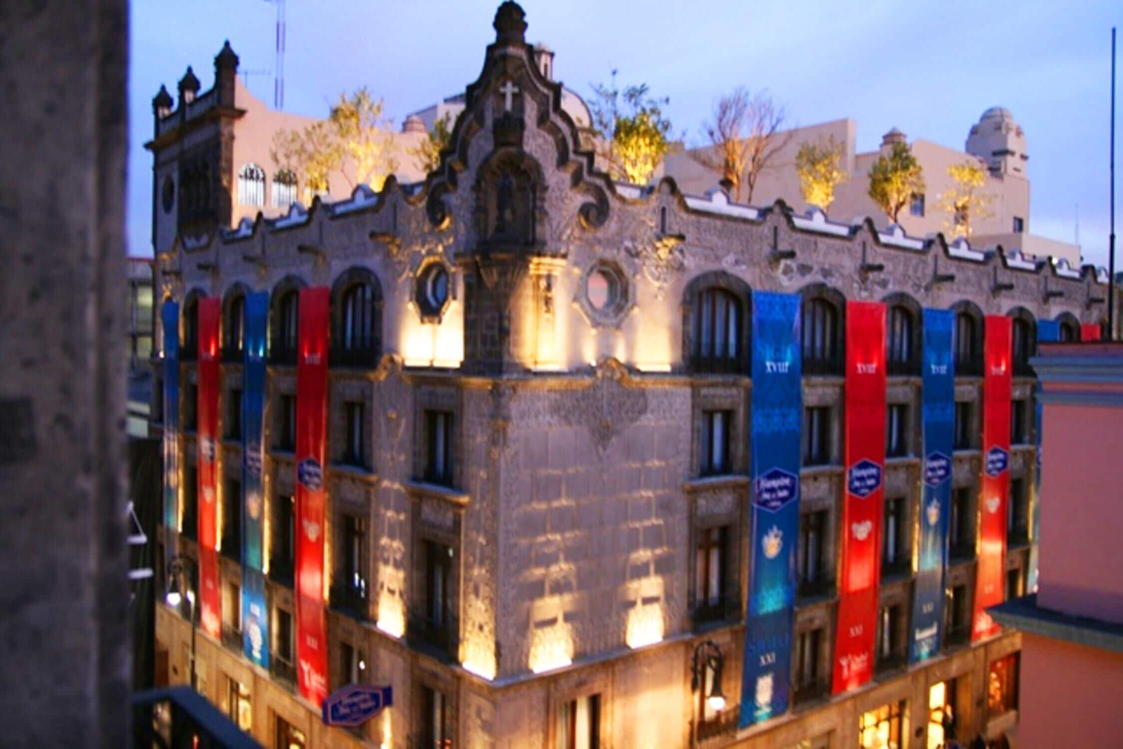 A historic building with multiple balconies and a prominent tower.