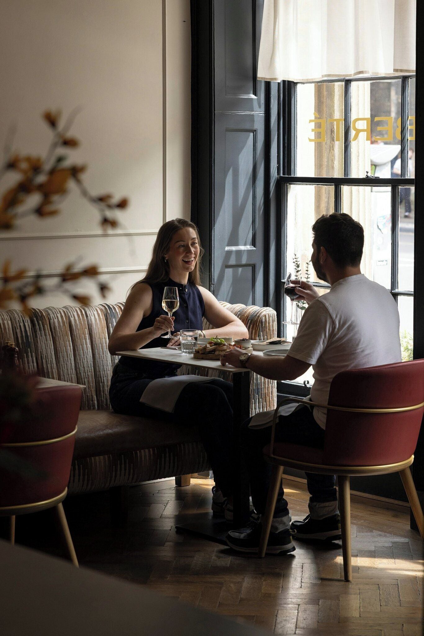 A dining area with a table, chairs, and a sofa.