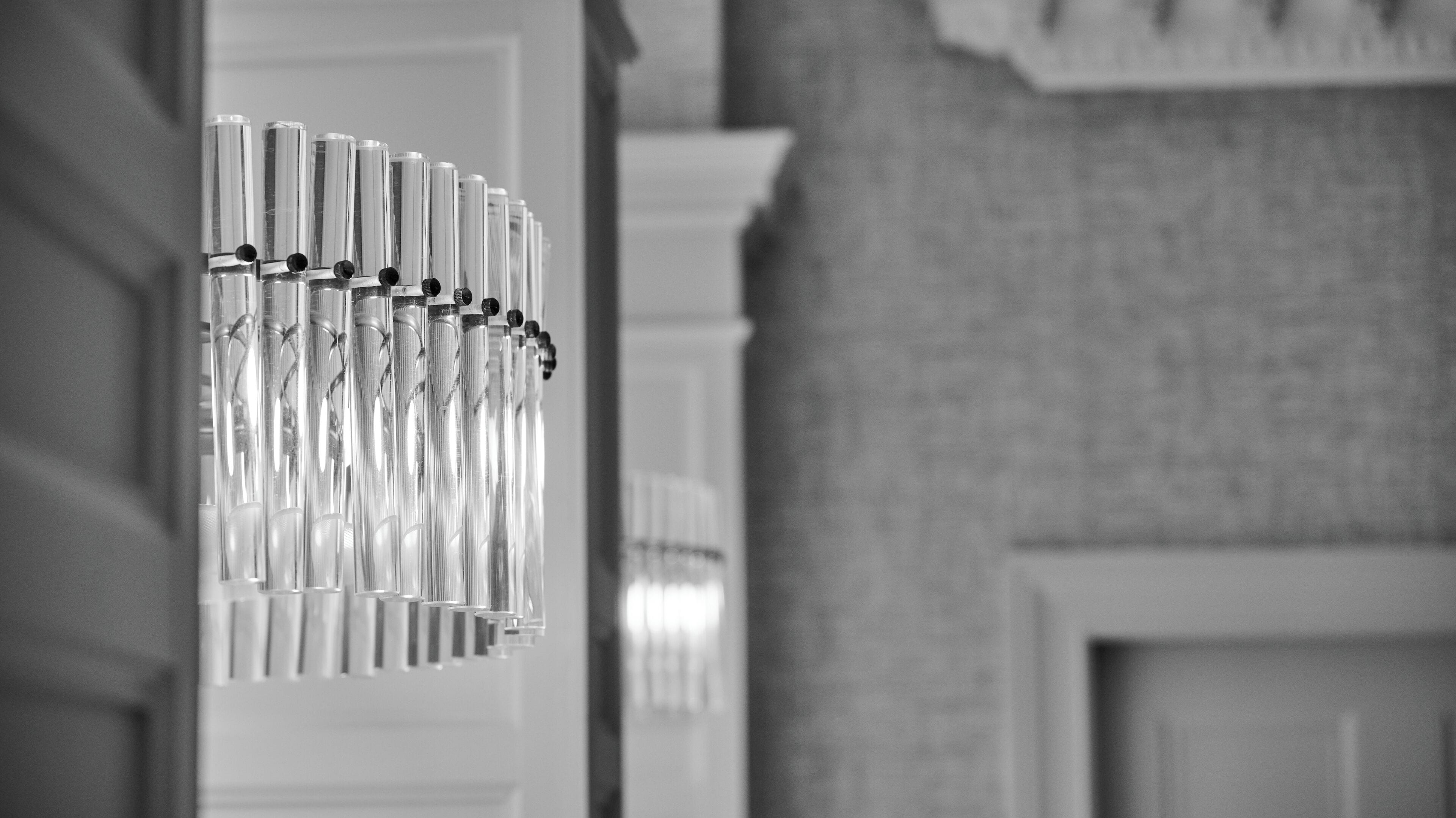 A hallway with a series of hanging, reflective objects.