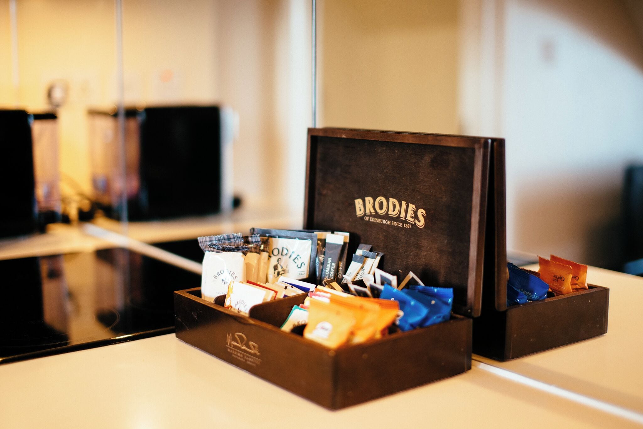 A box of Brodie's coffee with various coffee pods visible.