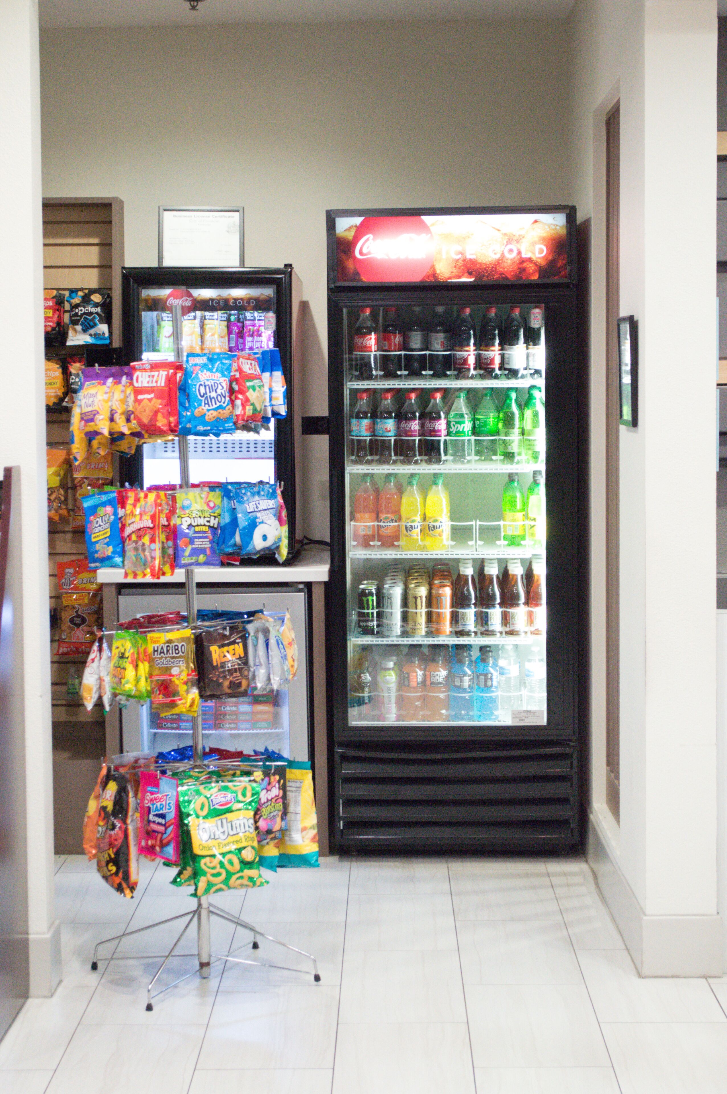 A vending machine stocked with snacks and drinks, and a display of packaged goods.