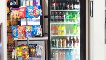 A vending machine stocked with snacks and drinks, and a display of packaged goods.