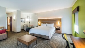 A hotel room with a large bed, a desk, a chair, a sofa, and a bedside table. - Holiday Inn Express & Suites Franklin KY by IHG (Franklin)