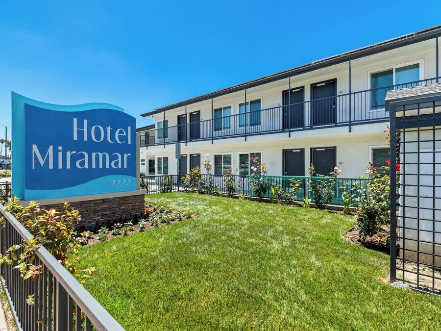 A hotel sign with the name 'Hotel Miramar' and the number '2222' indicating the building.