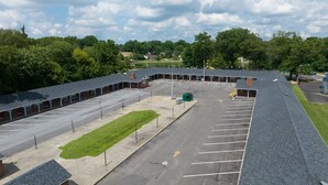 A parking lot with a building in the background. - Budget Inn and Suites (Mount Ephraim)