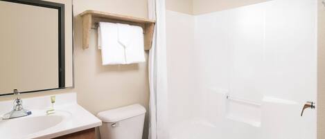 Un baño con inodoro, lavabo, espejo y bañera.