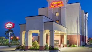 A Hampton Inn & Suites hotel with a prominent neon sign, a covered entrance, and a well-lit facade. - Hampton Inn & Suites Oklahoma City - South (Oklahoma City)