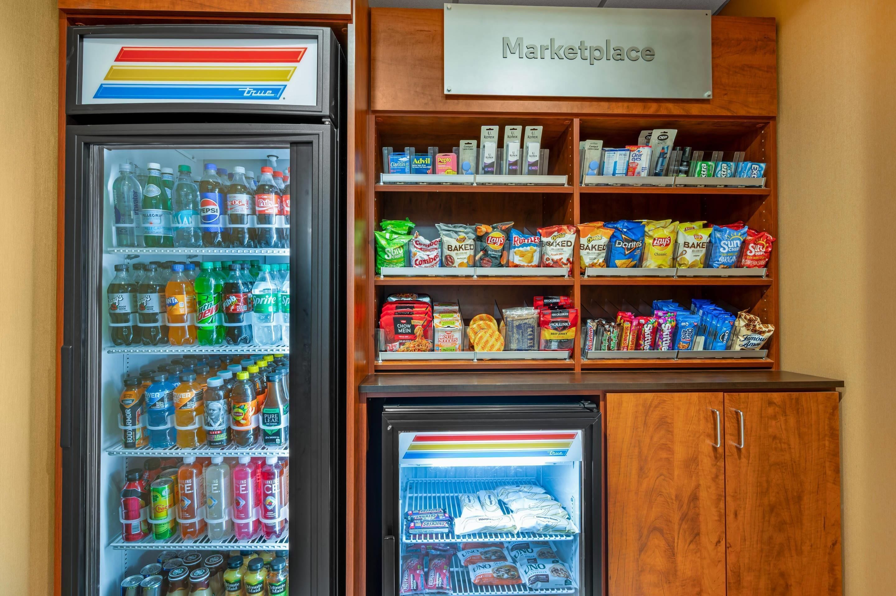 A vending machine with a variety of drinks and snacks, and a sign labeled "Marketplace" above it.