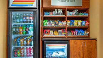 A vending machine with a variety of drinks and snacks, and a sign labeled "Marketplace" above it.
