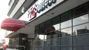 A hotel with a prominent sign reading "Premier Suites."