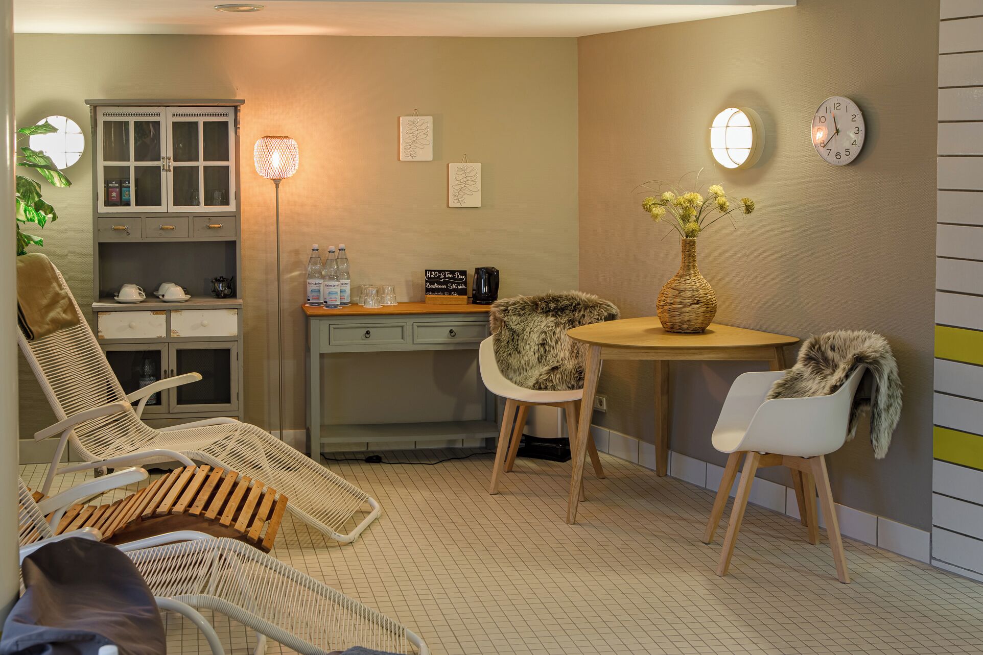 Una habitación acogedora con una mesa de comedor, dos sillas, un sofá, un armario y una lámpara.