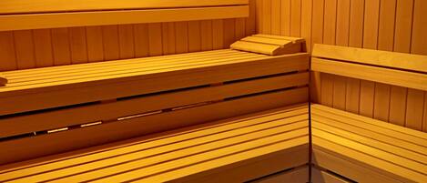 A sauna with wooden benches arranged in tiers.