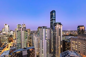 A high-rise urban skyline with modern architecture, including a distinctive curved building and several high-rise buildings with illuminated windows. - Oaks Brisbane Casino Tower Suites (Brisbane)
