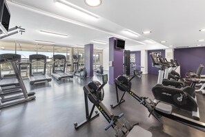 A gym with various exercise equipment, including treadmills and stationary bikes. - Oaks Brisbane Casino Tower Suites (Brisbane)