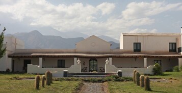 Un edificio de dos pisos con techo plano y entrada central.