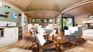 A spacious RV interior with a kitchen, dining area, and sleeping quarters. - Noosa North Shore Retreat (Noosa North Shore)