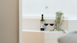 A bottle of wine and two glasses on a white tiled surface. - Best Western Tuscany On Tor Motor Inn (Newtown)