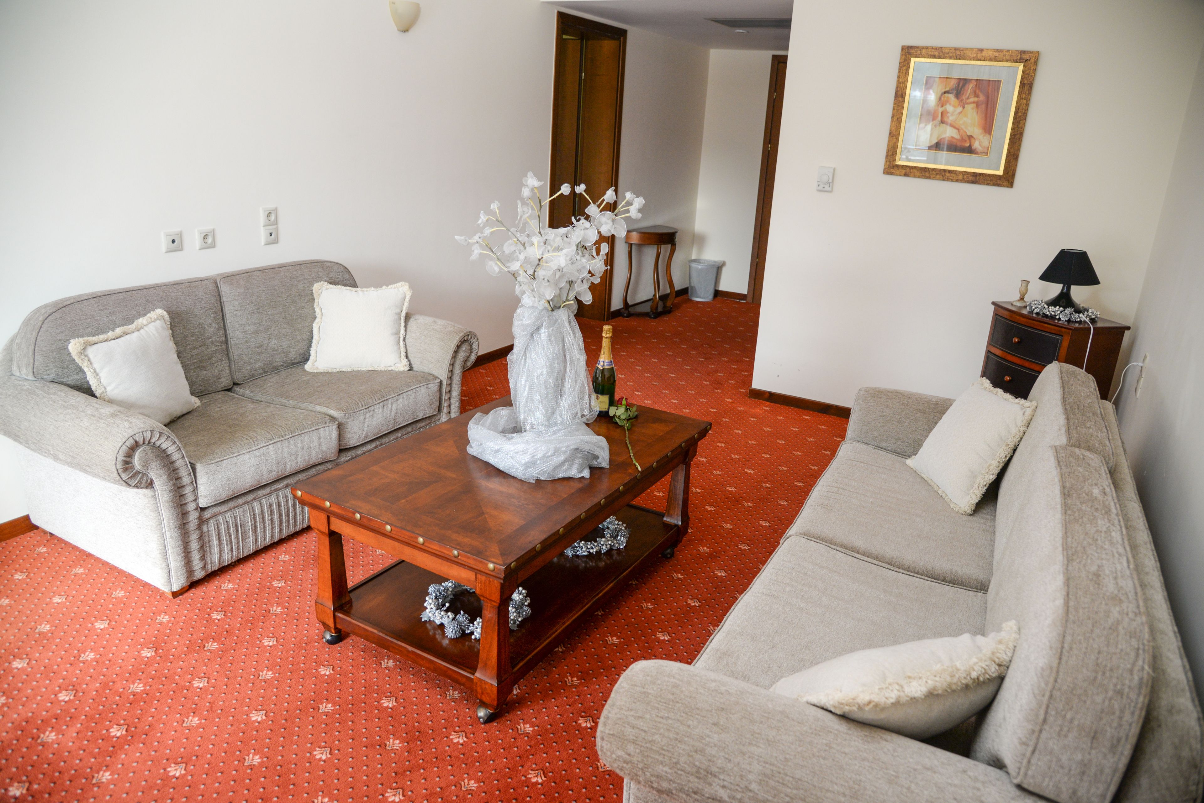 A living room with two sofas, a coffee table, and a small side table.