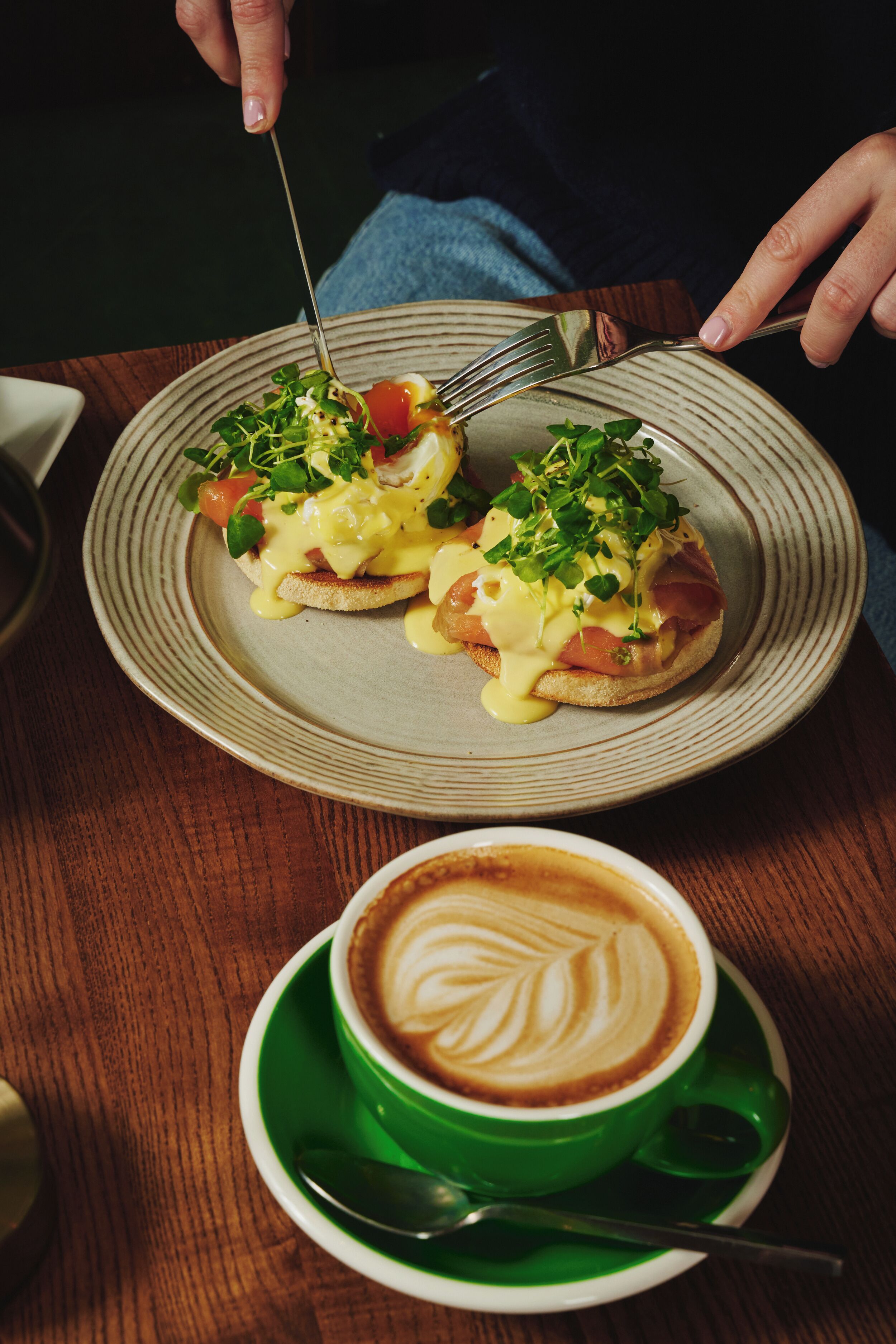 A plate with food and a cup of coffee on a table.