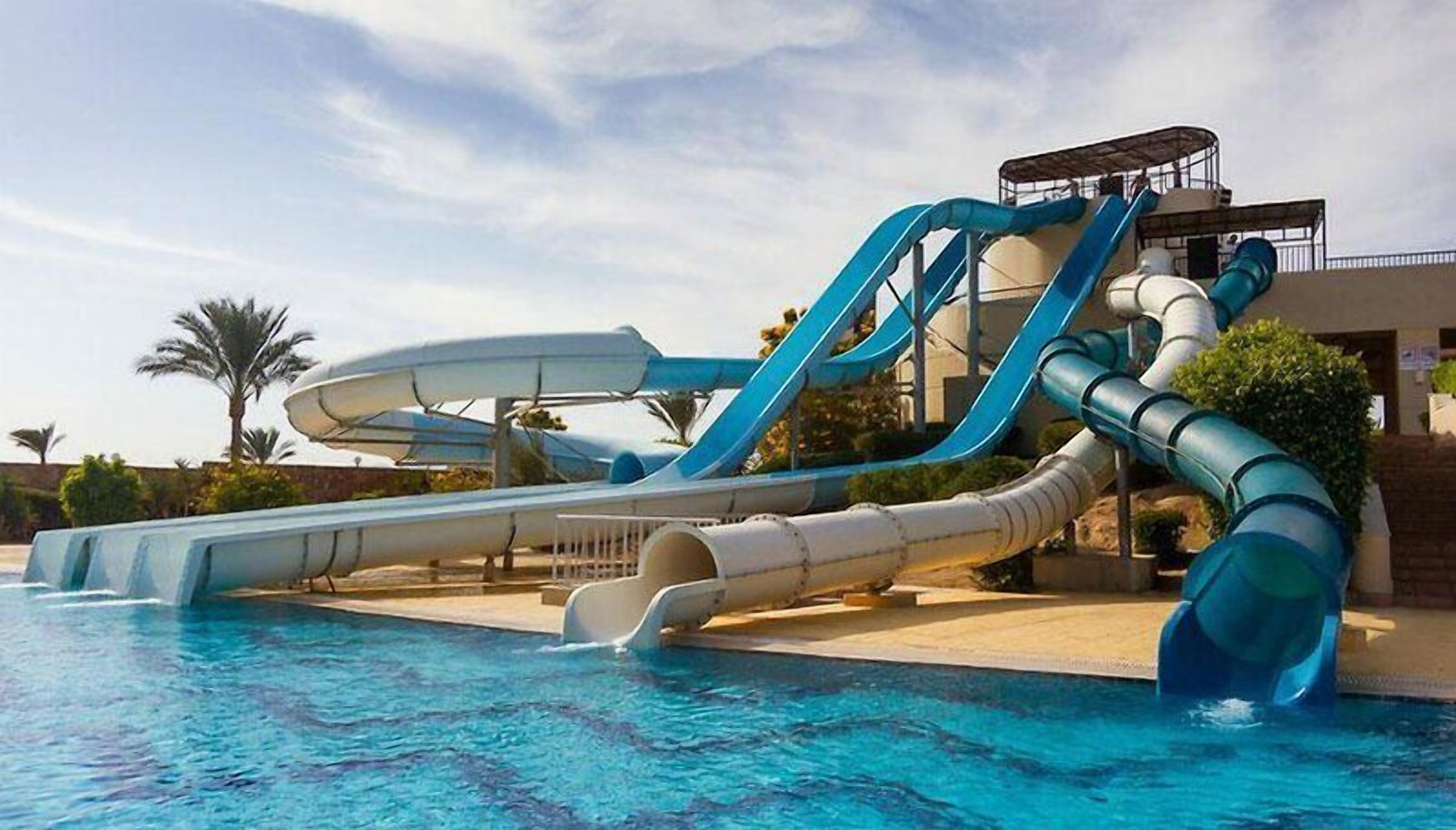 Parque acuático con varias toboganes y piscina.