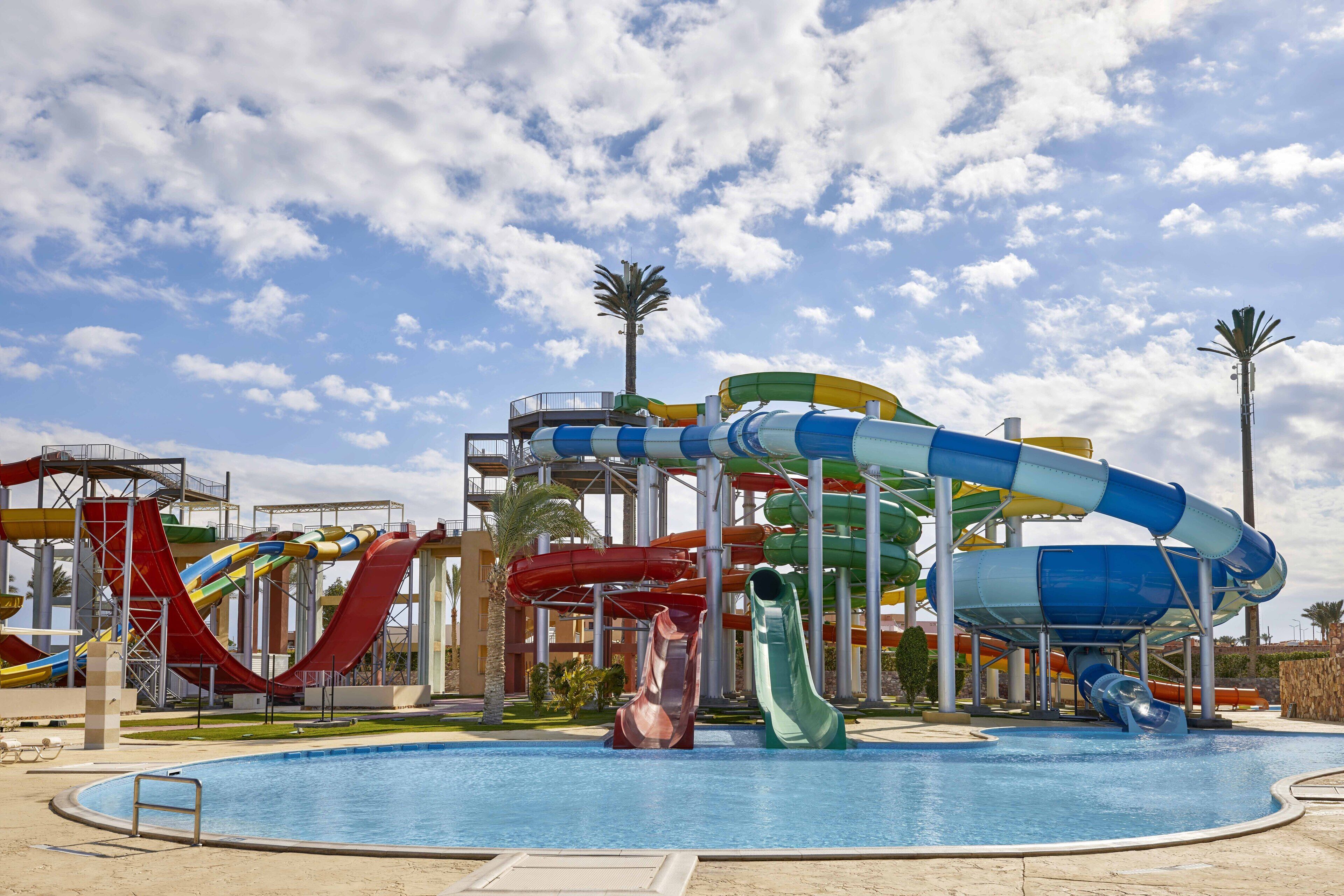 A water park with multiple slides and a pool.