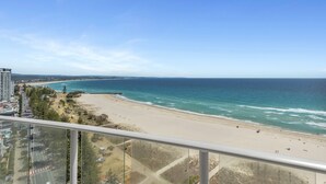 A coastal view from a high-rise building overlooking a beach with a clear sky. - Reflection Tower Two (Coolangatta)