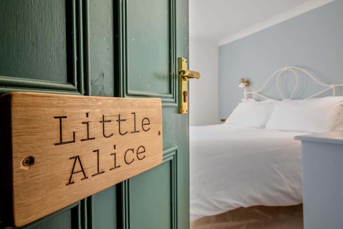 A wooden door with a sign reading "Little Alice."