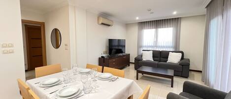 A modern living room with a dining area.