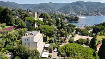A coastal town with a prominent tower, lush greenery, and a marina.