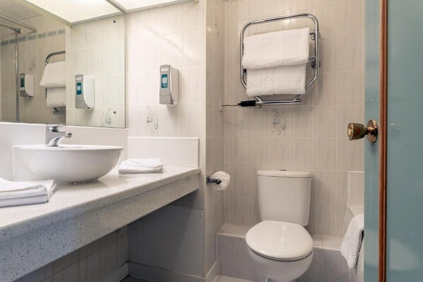 A modern bathroom with a large white sink, a toilet, and a shower area. - Passage House Hotel (Newton Abbot)