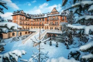 A large, historic building with multiple levels and a central staircase. - Grand Hotel Stamary Wellness & Spa (Zakopane)