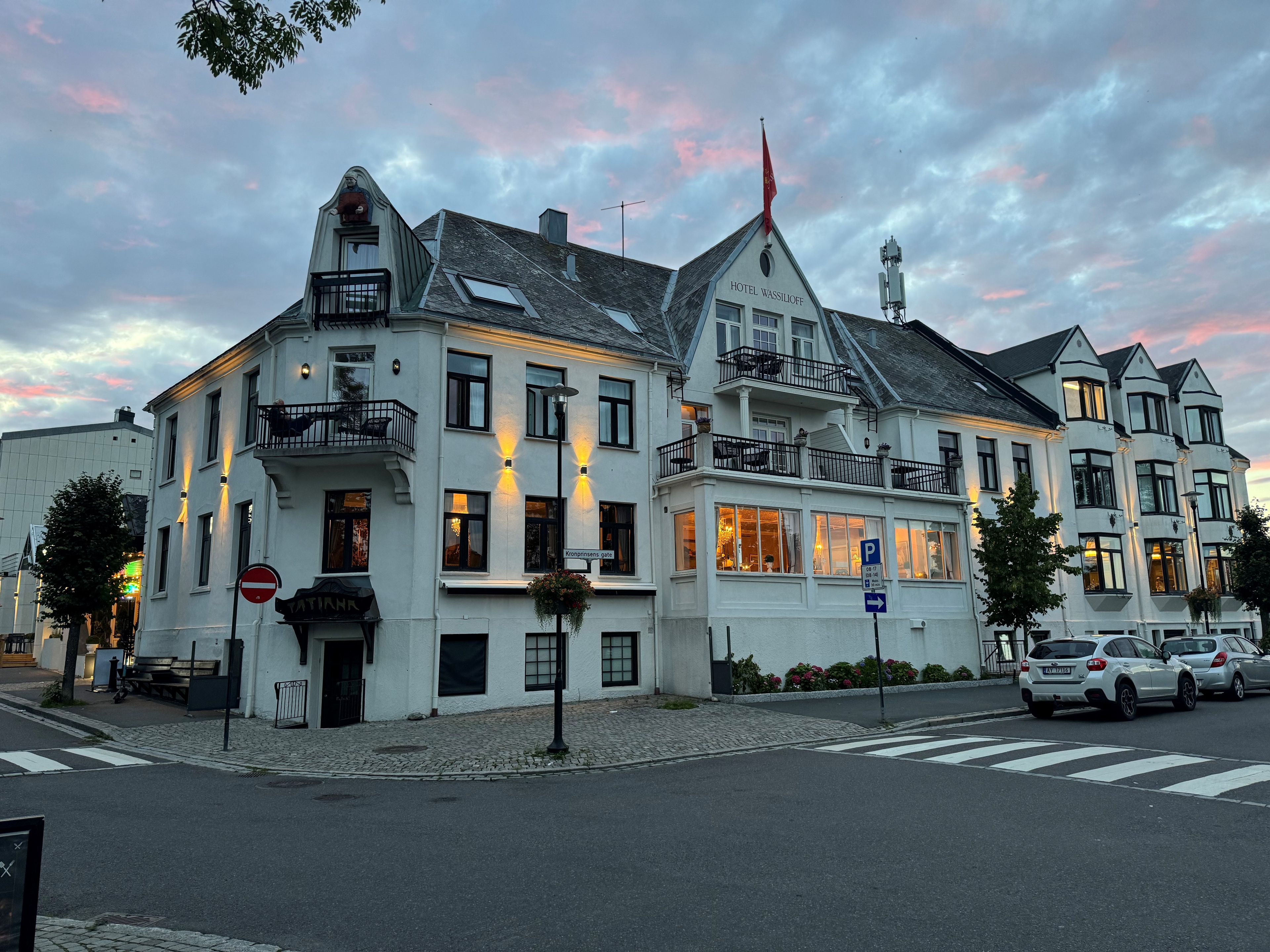 A white building with multiple balconies and a sign for 'Hotel Wassiloff.'