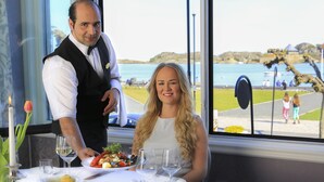 A dining table set with a white tablecloth, plates, cutlery, and wine glasses. - Hotel Wassilioff - Unike Hoteller (Larvik)