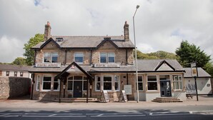 A traditional stone building with a sign reading "ROYAL HOTEL".