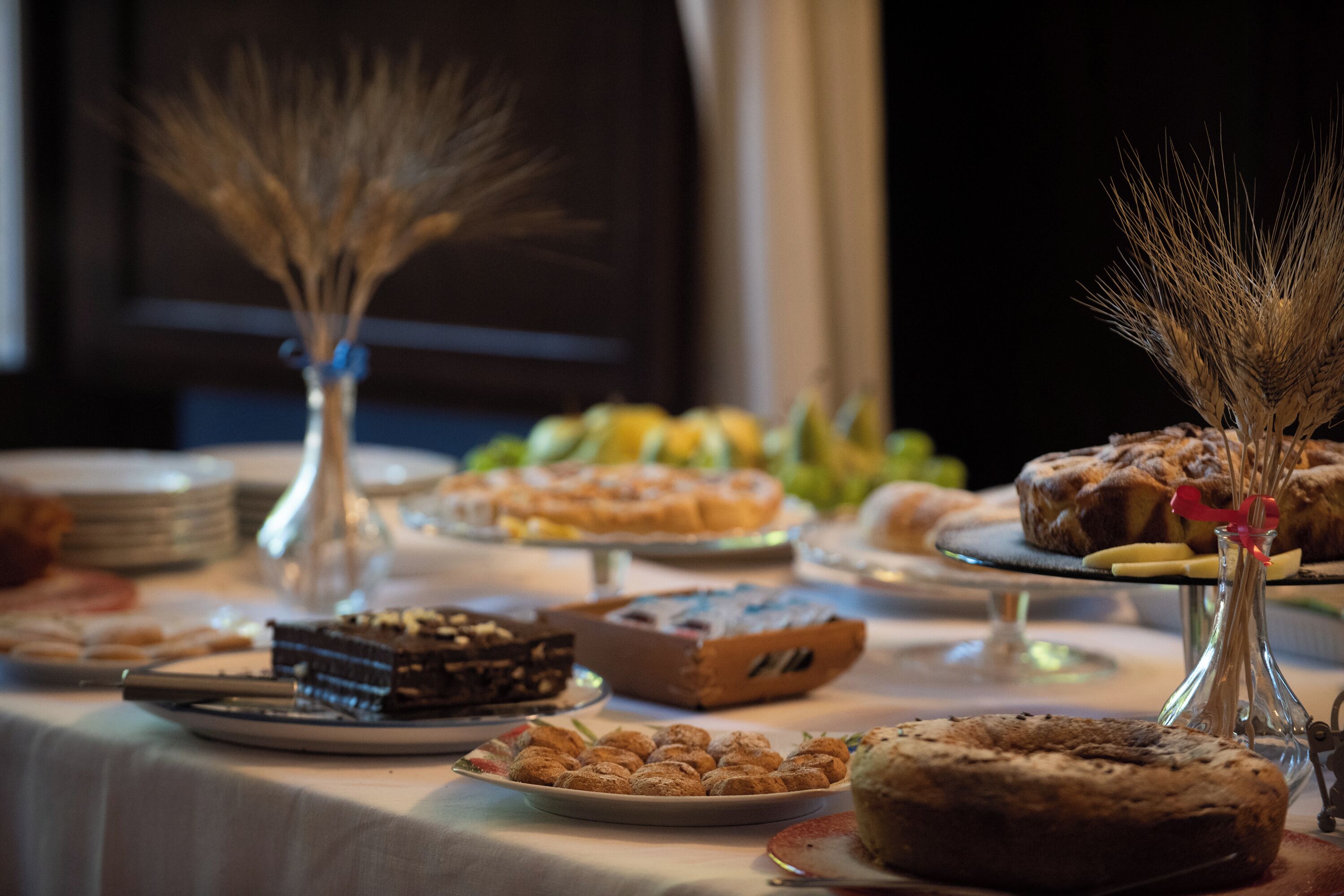 A buffet table with various desserts and pastries.